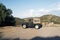 A vintage suv land vehicle in the beautiful scenic landscape of the island Patmos, Greece in summer