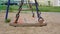 Vintage swings with rusty chains waved by wind on playground