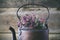 Vintage tea kettle full of thyme flowers for healthy herbal tea.