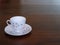 Vintage teacup on mahogany dining table