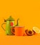 Vintage teacup, orange cup, lemon and pastry on orange background. Copy space on top