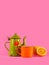 Vintage teacup,  orange cup and lemon on pink background. Copy space on top