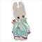 A vintage teddy bunny or bunny in an old fashioned yet stylish pastel colored outfit. Toy hare on a vintage postcard.