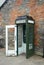 Vintage telephone booth on a street in rural Ireland