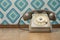 Vintage telephone on diamond wallpaper