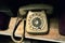 Vintage telephone on wooden table. Old phone rarity, antiques