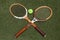 Vintage Tennis rackets and Slazenger Wimbledon Tennis Ball on grass tennis court.