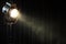 Vintage theater spot light on black curtain