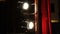 Vintage theatrical spotlight behind red curtain