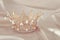 Vintage tiara over white delicate silk. Wedding concept