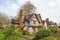 Vintage timber-framed building with lush greenery. Selly Manor Museum.