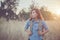 Vintage tone images of beautiful young hipster woman with backpack walking on meadow. Portrait of hiker girl outdoor.