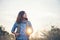 Vintage tone images of beautiful young hipster woman with backpack walking on meadow. Portrait of hiker girl outdoor.