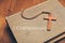 Vintage tone of wooden Christian cross necklace on holy Bible wi