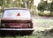 Vintage toned photo of the old bear toy on the retro rusty car outdoors