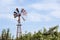 Vintage toned photo of an old western windmill tower, American wild west symbol .