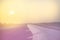 Vintage toned plane wing above runway at sunrise