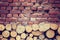 Vintage toned tree stumps and old brick wall background