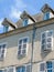 Vintage top of simple original townhouse with shuttered windows in French Pyrenees, France. Vertical photo