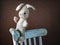 Vintage toy rabbit.Old vintage soft toy hare sits in old white chair