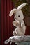 Vintage toy rabbit.Old vintage soft toy hare sits in vintage white chair