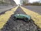 Vintage toy racing car, taken on a real road background showing double yellow lines going into the distance, diagonal perspective