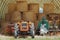 Vintage tractor and agricultural machineries under a wareing building with stacked hay bales