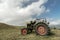 Vintage tractor in mountain field