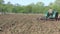 Vintage tractor pulling a harrow.