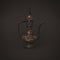 Vintage traditional islamic oriental engraved pitcher handmade on dark background. Elegant arabian antique tall metal jug