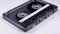 Vintage transparent audio cassette rotates on white background