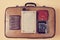 Vintage travel. Travelling background. Travelers set. Top view of retro suitcase, passport, purse, old book and camera