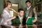 Vintage trio of people in period costume sitting around piano playing tunes and singing songs