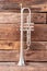 Vintage trumpet on old wooden background.