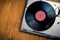 Vintage turntable with disc on wood