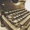 Vintage typewriter close up in sepia tone with old fashioned keys