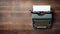 Vintage Typewriter on a Distressed Wooden Table with Ample Space for Text