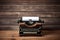 Vintage typewriter on rustic wooden background