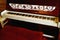 Vintage Upright Piano with an Empty Stool in Foreground