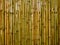 Vintage vertical brown and green bamboo fence texture background