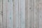 Vintage vertical gray colour wooden boards with remains paint as background