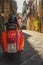 Vintage Vespa Piaggio parked in a street of a Tuscan town. Italy, 2017.