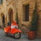 Vintage Vespa Piaggio parked in a street of a Tuscan town. Italy, 2017.