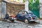 Vintage Vespa scooter and Fiat 500 parked in a picturesque narrow street