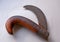 Vintage vine cutting knife on a white background. Old and rusted curved knife for cleaning, pruning, and cutting