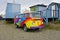 A vintage Volkswagen (VW) camper van painted with psychedelic hippy colors