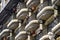 Vintage wall of a building with many balconies with wrought iron cast-iron fencing