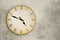 Vintage wall clock over grey grunge background