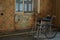 Vintage wheelchair and dusty floor in old house