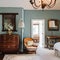 Vintage Whispers: A charming attic bedroom with vintage suitcases repurposed as nightstands, an antique vanity table, and an old